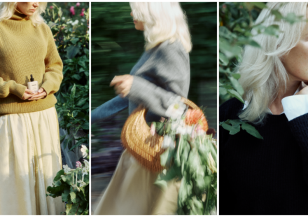 Pamela Anderson in a garden wearing a mustard sweater and holding Sonsie Skin skin care; walking with a flower-filled basket; close-up profile showing bare, natural skin.